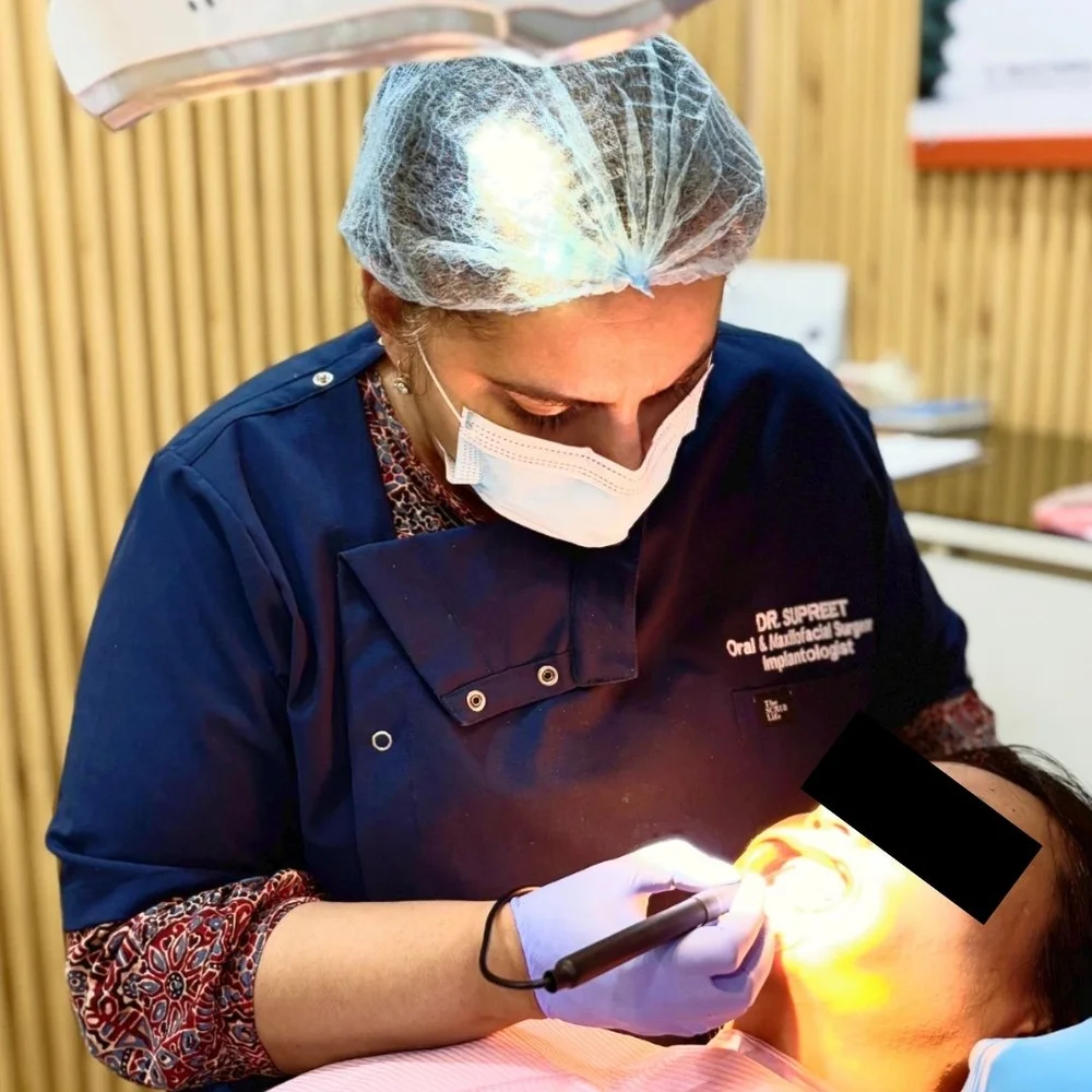 Dr. Supreet Kaur Sawhney providing clinical dental treatment to a patient