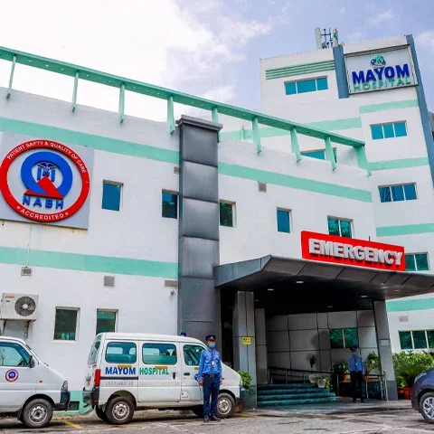 Exterior of Mayom Hospital in Gurugram with the main entrance and emergency signage